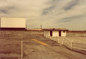 This is a photo of the projection booth with the screen in the background after the last show was shown.