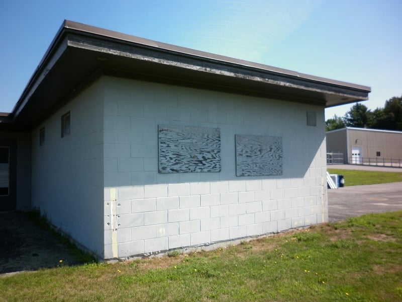 Projection portholes covered with plywood