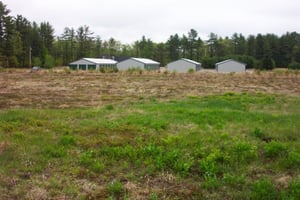 View from rear of lot looking toward main road.  Storage buildings are visible.