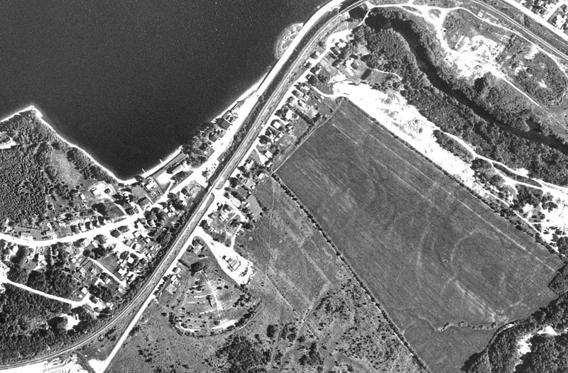 photocartothèque québécoise aerial photograph (there are no USGS photos)

The drive-in is on the left, the border is the railway line, this drive-in is accessable only via Quebec.