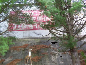 Photo of the deer statue and fountain that stands in front of the drive-in sign at the Saco Drive-In.