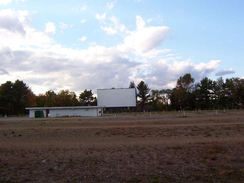 Photo from the open grassy area that appears to have once been the concourse area at the back of the lot. The Saco Drive-In.