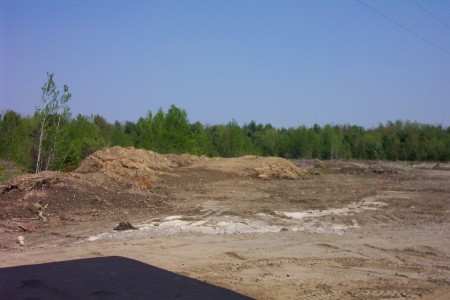 View of former lot taken from the new road being cut into the property for modular home displays.