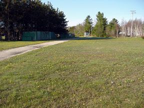 Real estate picture of driveway and ticket booth.