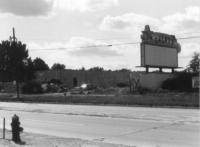 Picture of Galaxy Drive-In Marquee with construction in progress Madison Tech Center building on left.