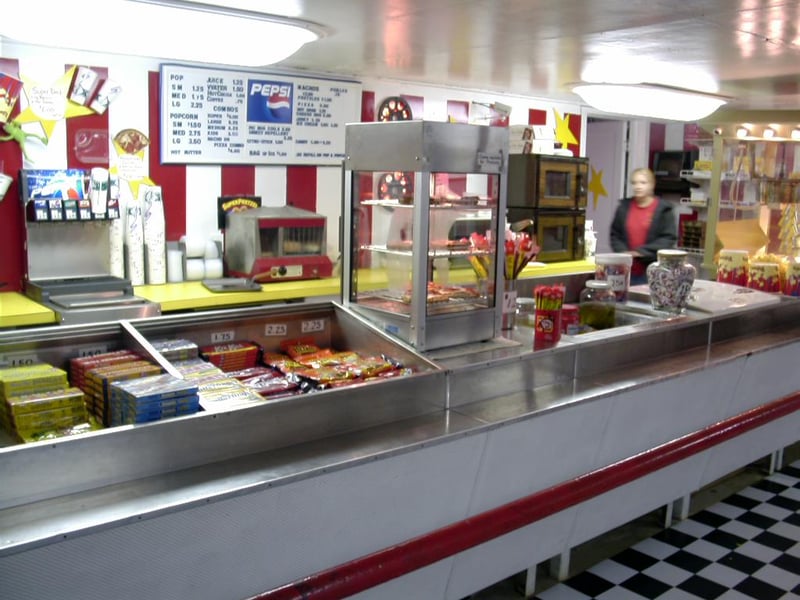 Concession stand employee greets arriving customers.