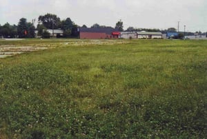 On the left of the field runs the entrance road