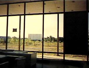 M-78 Twin Drive-In Blue (south) Screen, shot from inside the snack
bar. Screen was demolished November 1999. Snack bar still standing as of
November, 2001.