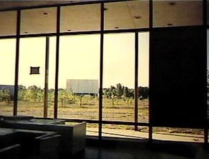 M-78 Twin Drive-In Blue (south) Screen, shot from inside the snack
bar. Screen was demolished November 1999. Snack bar still standing as of
November, 2001.