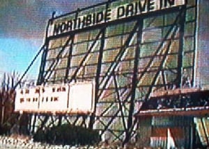 Vidcap of the Northside Drive-In screen tower and ticket booth from the extensive archives of Outdoor Moovies, a Lansing public-access cable TV program produced by Darryl Burgess.