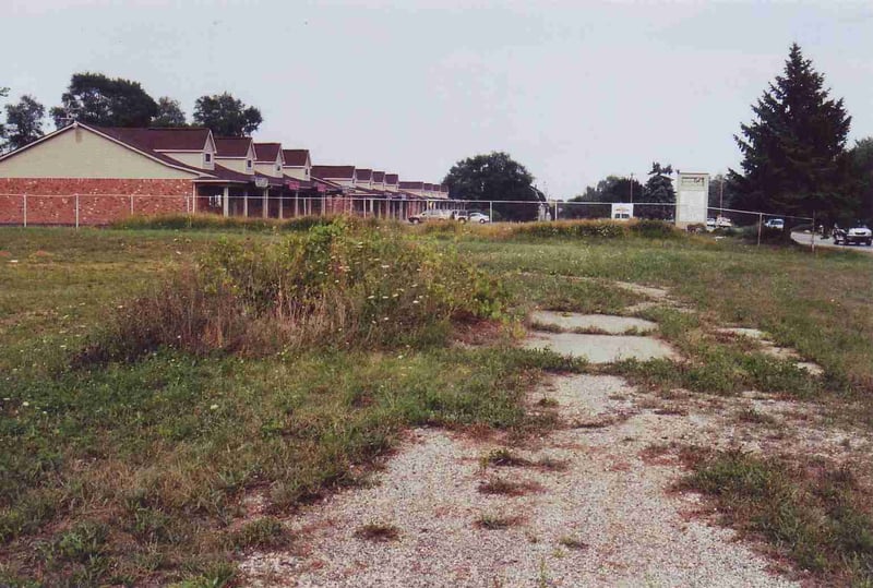 Entrance road. The plants on the left mark the spot where the ticket booth once sat