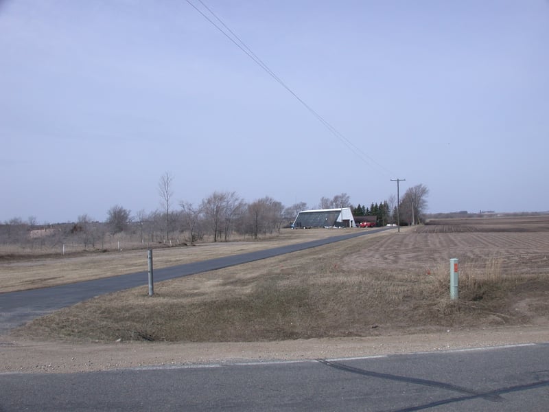 The remains of the Skyvue Drive-in. The white building is actually the base of the former screen, which was also enclosed used for winter storage by the Skyvue. Now it is a machine shed. Everything else is gone, and all other buildings and fixtures as