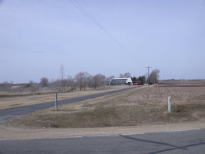 The remains of the Skyvue Drive-in.  The white building is actually the base of the former screen, which was also enclosed  used for winter storage by the Skyvue.  Now it is a machine shed.  Everything else is gone, and all other buildings and fixtures as