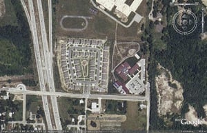 Aerial view of former drive-in site with housing