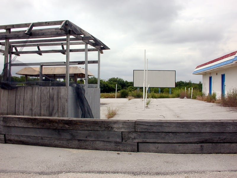 Screen, unrecognizable outdoor structure (left) and main building (right)