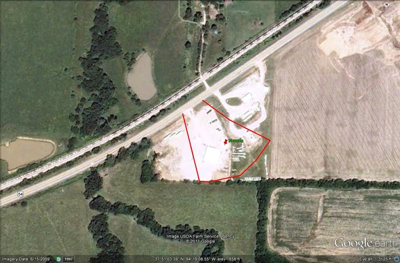 Google Earth image with outline of former site on south side of US-54 to the east of town