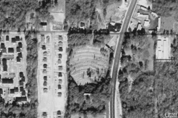 Picture of the remnants of the Broadway from before it was torn down shows ramps grown up with shrubs/weeds, and screentower.