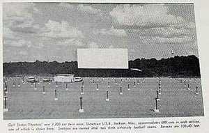 Caption: Gulf States new 1200 car twin airer, Showtown USA, Jackson Miss, accomodates 600 cars in each section, one of which is shown here. Sections are named after two state university football teams. Screens are 100 x 40 ft.