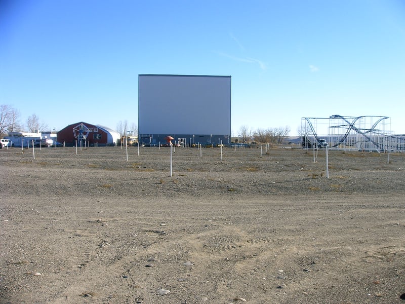 The screen tower. It is a two sided screen tower. It was formally the tower at the Park Drive-In in Cody, WY. Amusement rides are on both sides of the tower. This theatre represents the only amusement park in MT