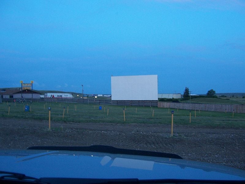 At the Sunset Drive-In after paying admission to see the night's show. Showed up early, it got packed soon after this was taken. View of the screen and parking area.