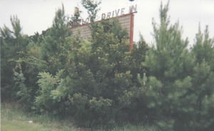 Overgrown Marquee. Torn down and now a Post Office.