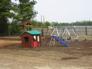 Our newly expanded playground with a fort,swings and riders for children