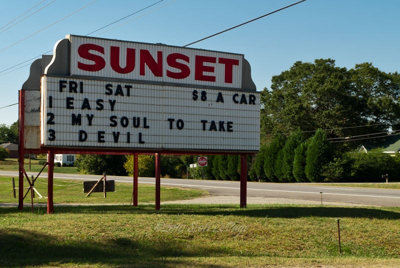 Sign of the Sunset Drive-In movie detailing admission price and current movies showing. Hwy NC150 Shelby, NC USA 10 Oct 2010 Scott LePage