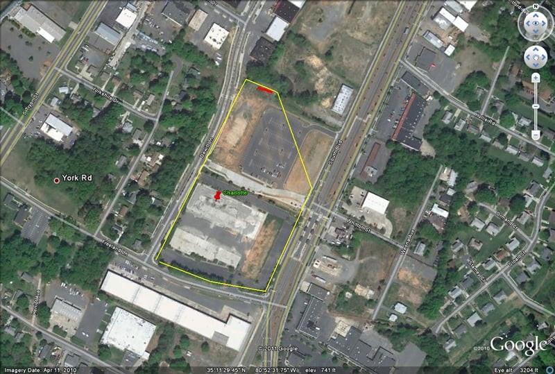 Outline of former site with screen on North end of site-now empty lot with demolition debris