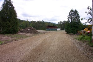 Access road cut through property where screen one used to be, snack bar in background.