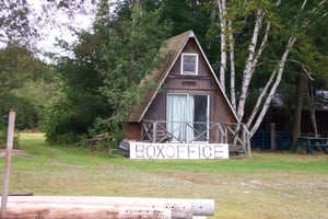 Small building at rear of property.  The sign reads "Box Office."