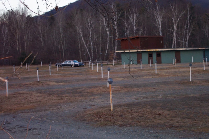 Lot view with snack bar/projection building.  You can see one car in the lot.  I don't know if that was the last car to see a show at this theatre.