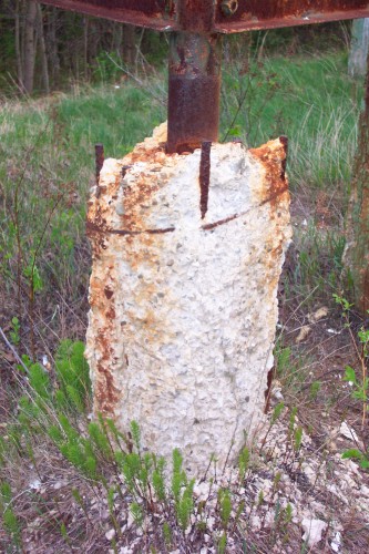 Decaying cement footing of screen tower.