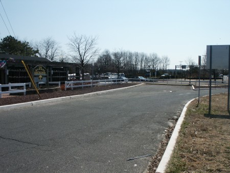 View from "Harvest Exchange" that shows original access road now dead ended into their parking lot. The access road still continues after the parking lot.