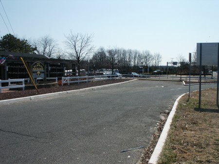 View from "Harvest Exchange" that shows original access road now dead ended into their parking lot. The access road still continues after the parking lot.