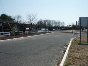 View from "Harvest Exchange" that shows original access road now dead ended into their parking lot. The access road still continues after the parking lot.