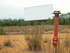Field with speaker post and screen.