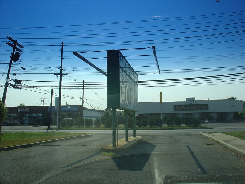 Wide view of entrance sign on the way out.