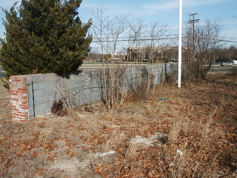 Screen tower rear anchor foundation supports. A brick facade  with a flag pole covers these supports from the street.