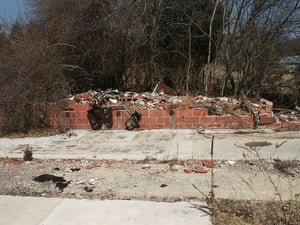 Foundation & remains of projection booth. You can still clearly see where the two projectors once stood. An RCA audio amplifier is still mounted to the back wall. Another mangled box next to the amp is where the projector nameplate photo was taken.