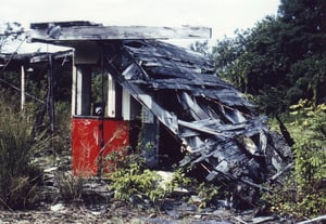 Shot of middle ticket booth with fallen down roof once connecting all 3 booths