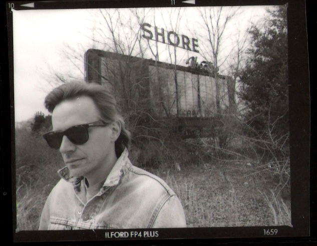 Ed Kaz in front of the Shore Drive In sign in 1995.