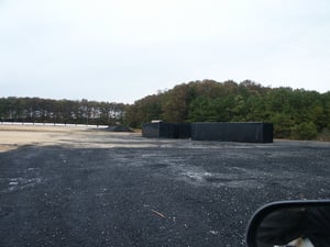 View of shipping containers that will be welded together to form the base of the screen.