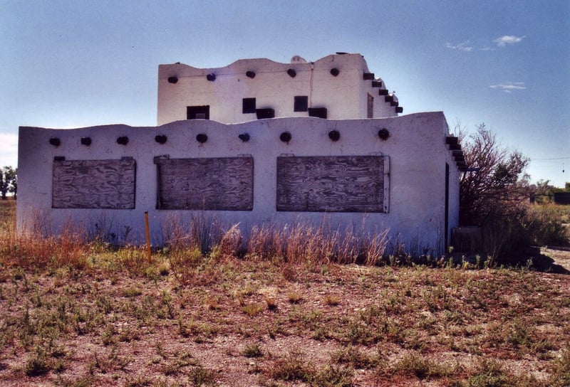 Boarded up 2-storey projection/concession building