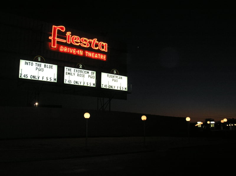 Fiesta Drive-In - back of screen at night, ticket booths off to right.
