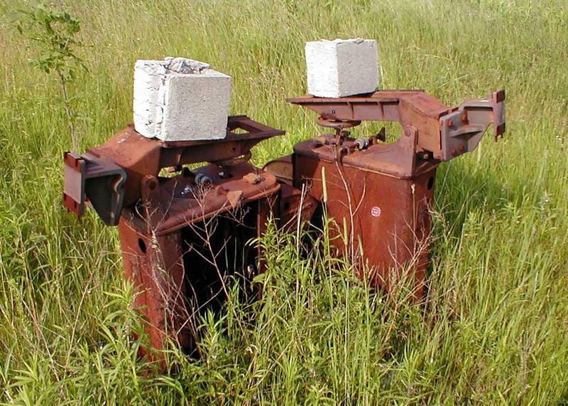 rusted RCA projector bases with cinder blocks holding them down