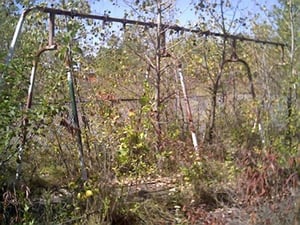 Old swing set poles still stand.