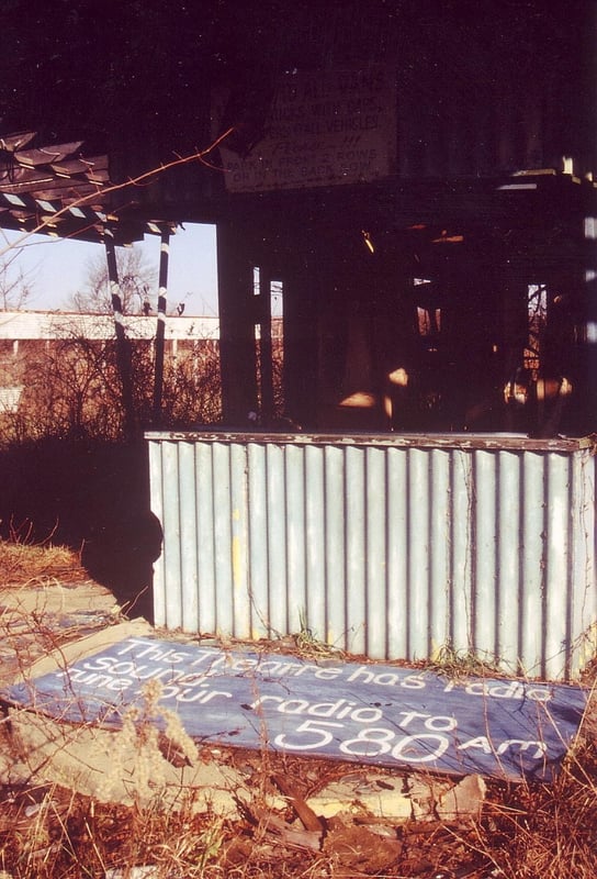 Close-up of ticket booth with fallen off info board indicating radio sound