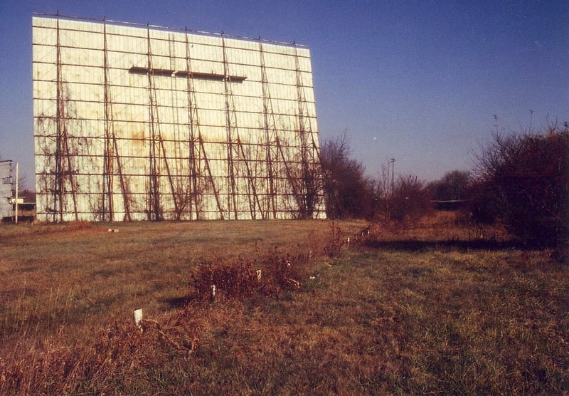 The overgrown ticket booth can be seen to the right of the screen tower