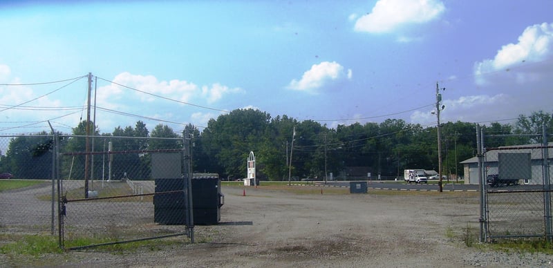 In this picture, facing the main road from in front of the concession stand. Right where the fence an this dumpster are is pretty much about where the screen was....to the left of the dumptster is about where the end of the screen was and where the ticke