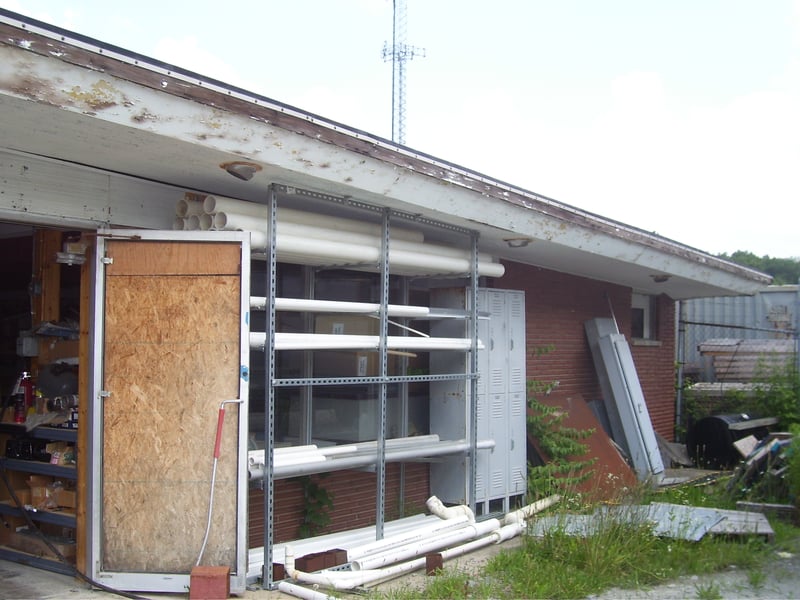 This is the right side of the old concession stand....as you can see, unlike the other side the glass in the double doors has been busted out and replaced by plywood, the the glass in the large windows just behind this scaffolding is intact.   The poor st